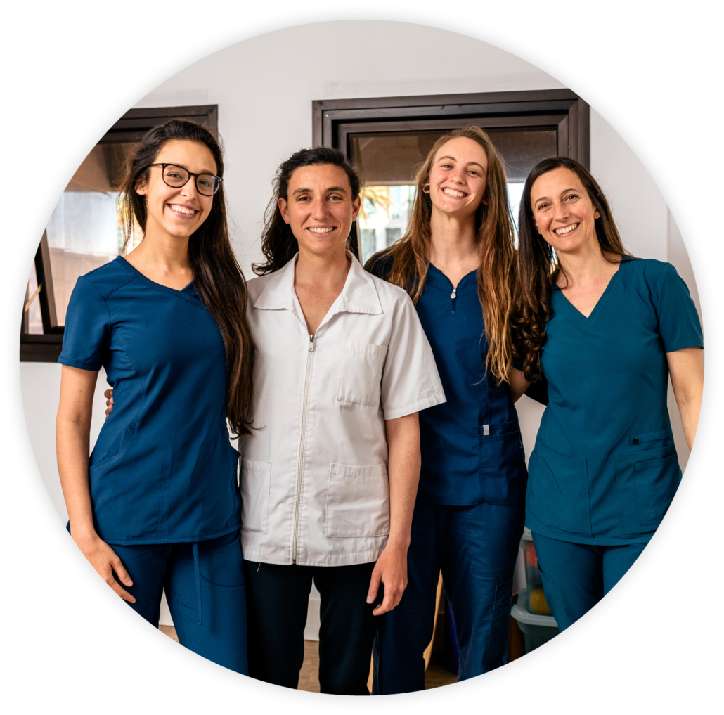 A group of four smiling healthcare professionals in uniforms, representing the caring and experienced clinicians at Pivot Rehabilitation. They are dedicated to delivering high-quality therapy solutions and patient-focused care.